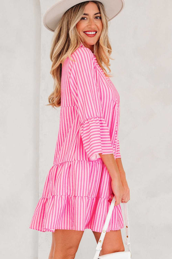 Front view of pink striped tiered flowy mini dress women with hat