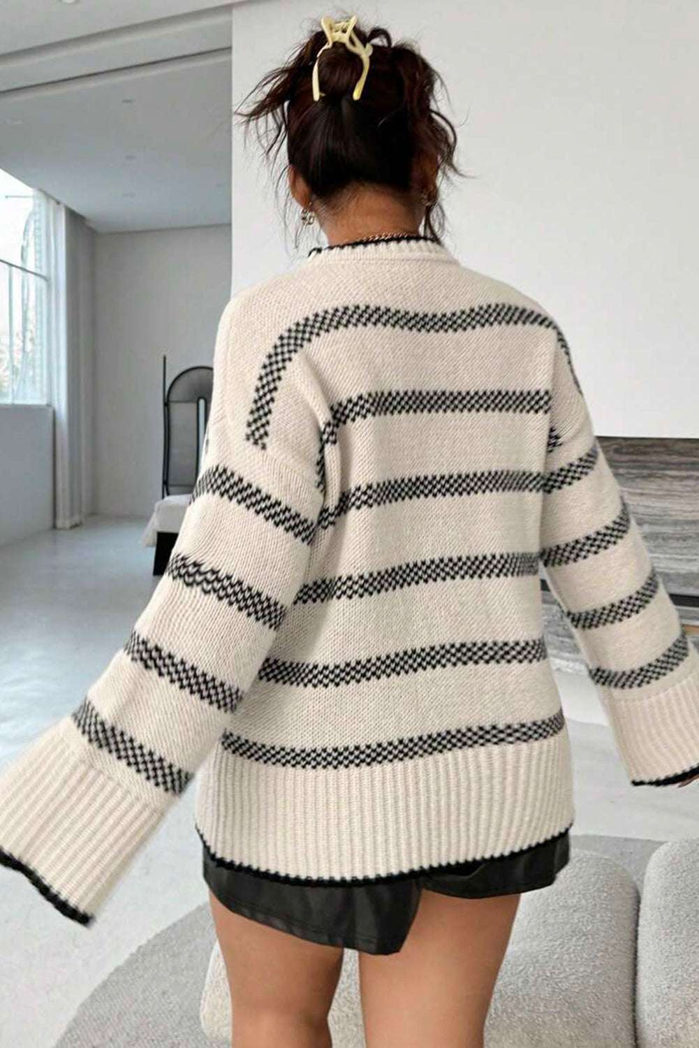 Back view of Women's Apricot Striped Bell Sleeve Jumper highlighting wide bell sleeves and horizontal stripe pattern. Perfect for autumn layering.