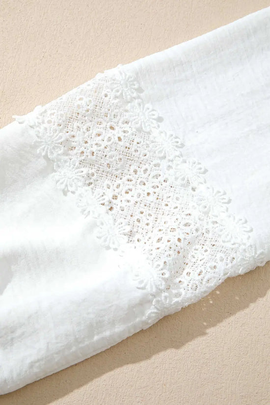 Detailed view of the floral guipure lace panel on the sleeve of the White Guipure Lace Frill Blouse, showcasing its intricate craftsmanship.
