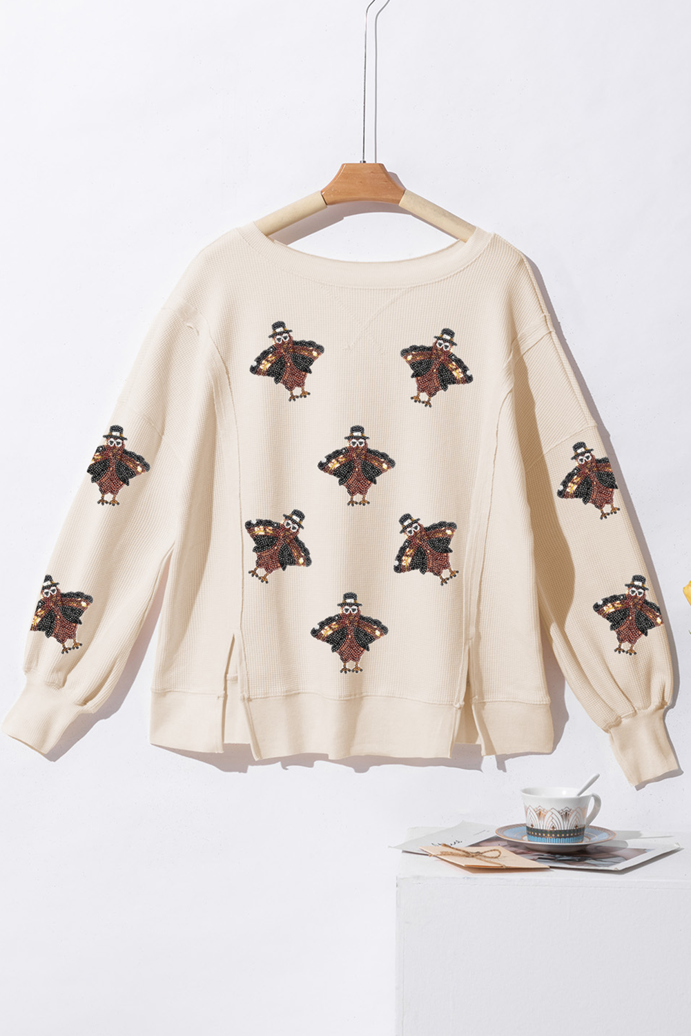 Thanksgiving Oversized Knit Top on a hanger against a white background.