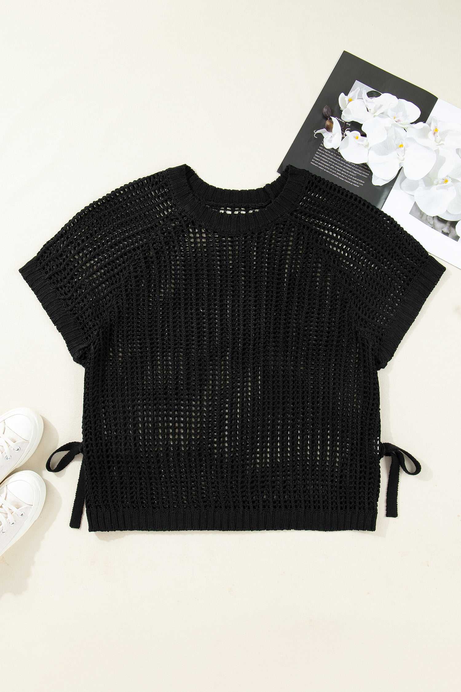 Flat lay of black Plus Size Bow Tie Open‑Knit Jumper for Women highlighting short sleeves, open-knit texture, and side bows.