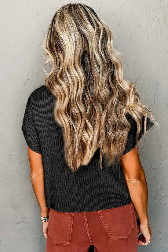 Back view of black ribbed knit short sleeve sweater worn by woman, showing relaxed fit and soft texture for daily wear.