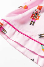 Close-up of Nutcracker print on pink satin fabric