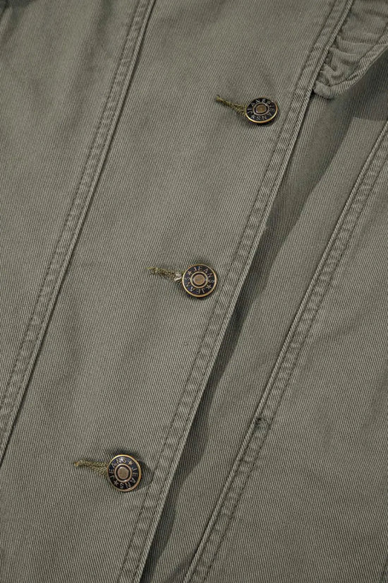Detailed view of buttons on Green Bay Ruffled Denim Vest - Women's Fashion Trends with metallic accents and reinforced seams.