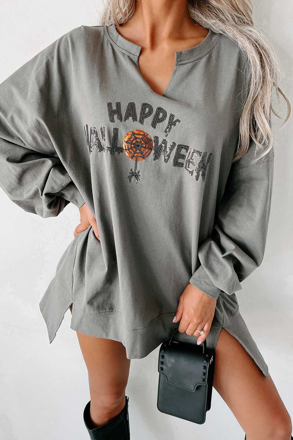 Grey Sequin Halloween Top with 'Happy Halloween' graphic and pumpkin web design, V-neck long sleeve tee styled with black accessories.