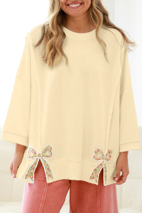 Woman wearing raw seam floral bow patched baggy plus size pullover