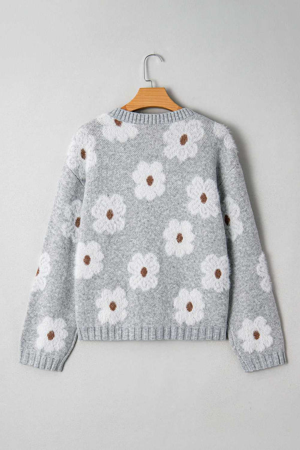 Back view of FashionFitz Oversized Grey Floral Knit Jumper – V‑Neck showcasing all-over white floral knit design on soft grey fabric.
