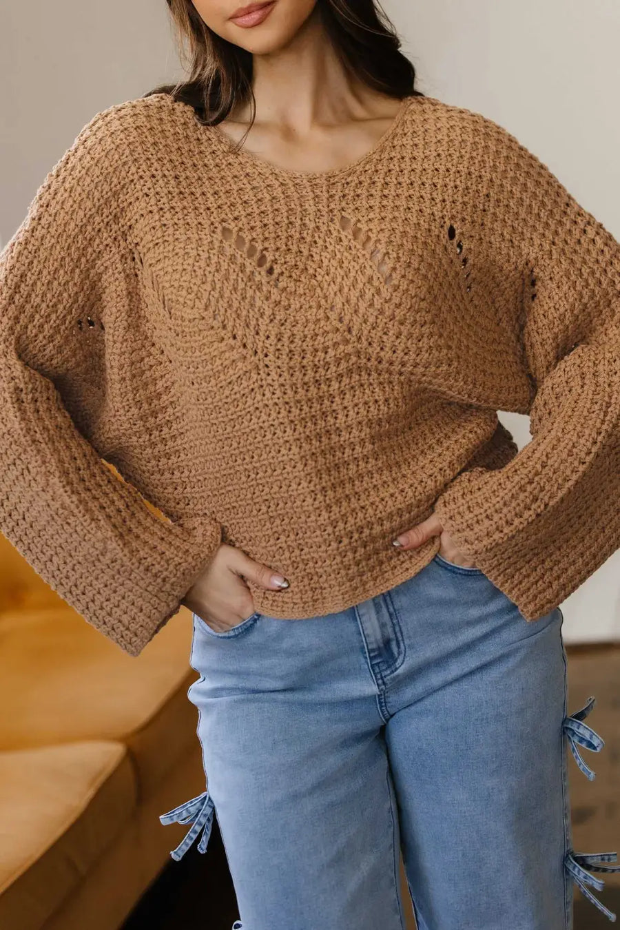 Close-up of tan Wide Sleeve Hollow Knit Jumper showing airy open-knit detail and wide sleeves, perfect for layering in fall fashion.