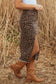 Side view of Leopard Denim Midi Skirt - Summer Fashion by FashionFitz with high slit and frayed hem, styled with boots.