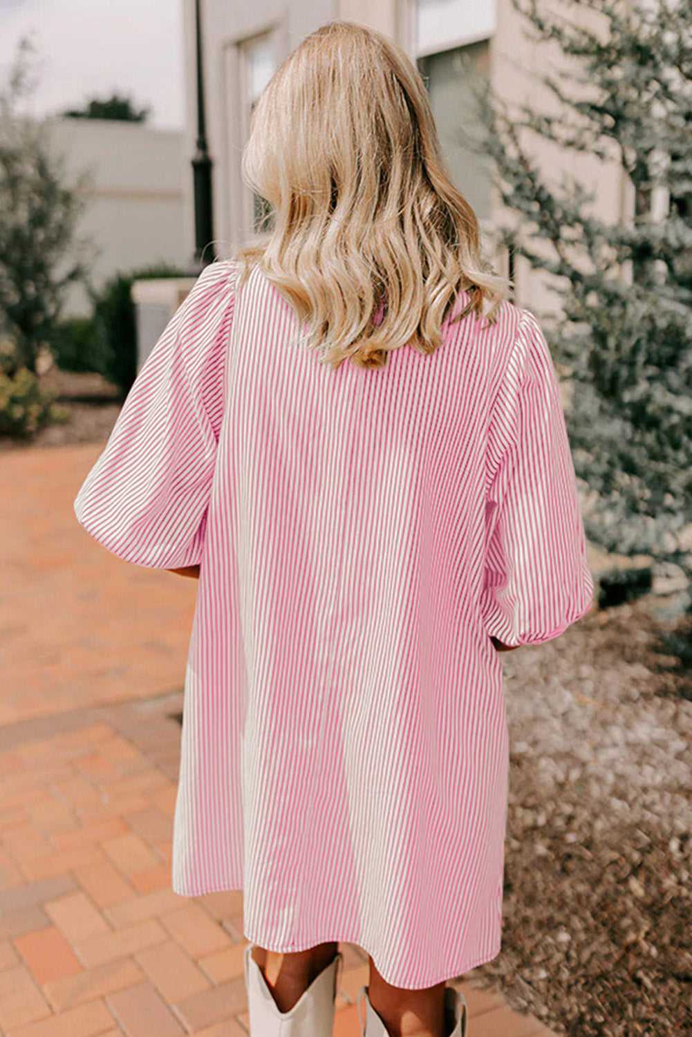 Back view of pink striped mini dress with puff sleeves and relaxed silhouette, designed for daily wear and summer comfort.