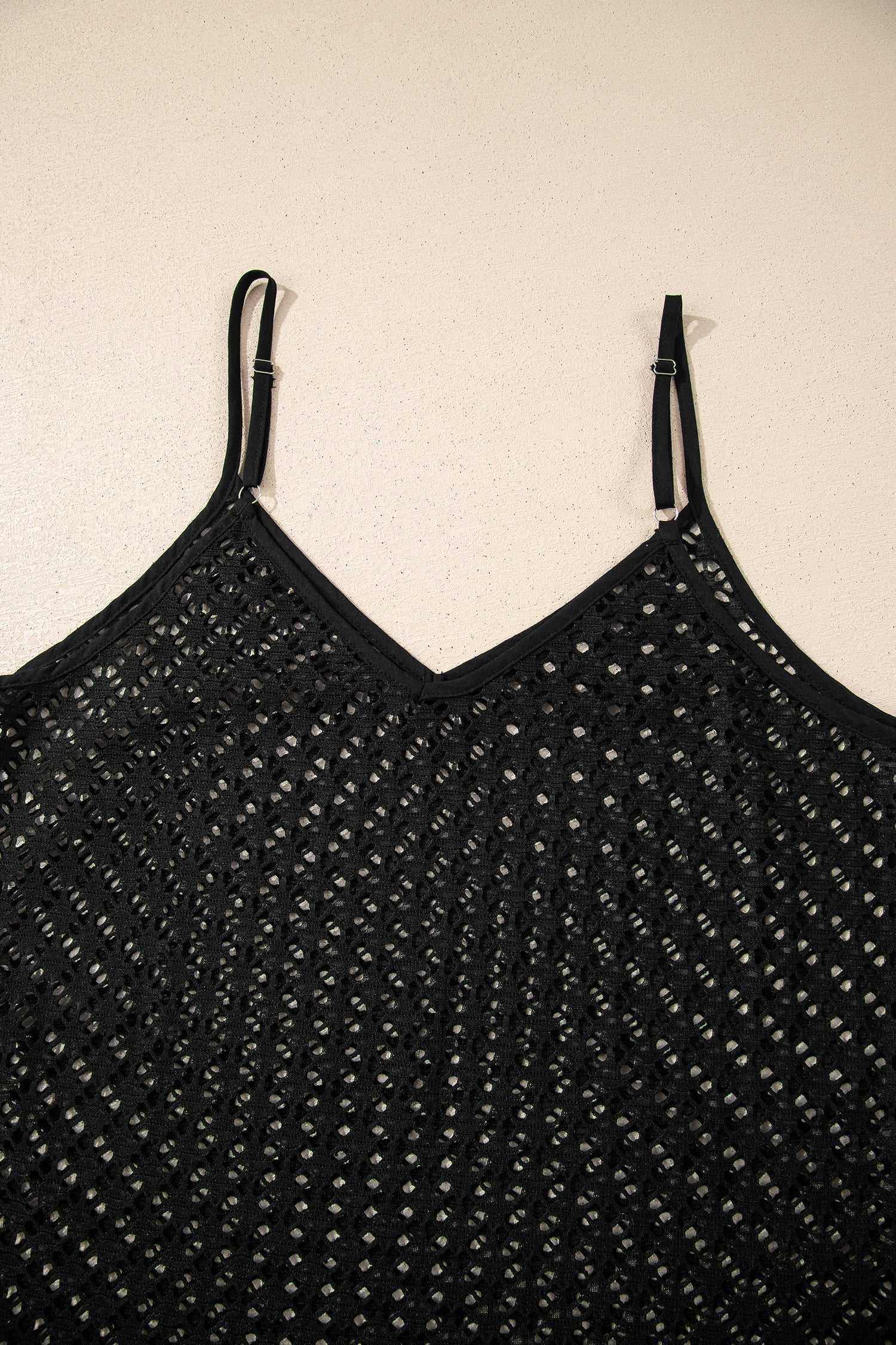 Top view of black crochet beach cover-up showing design