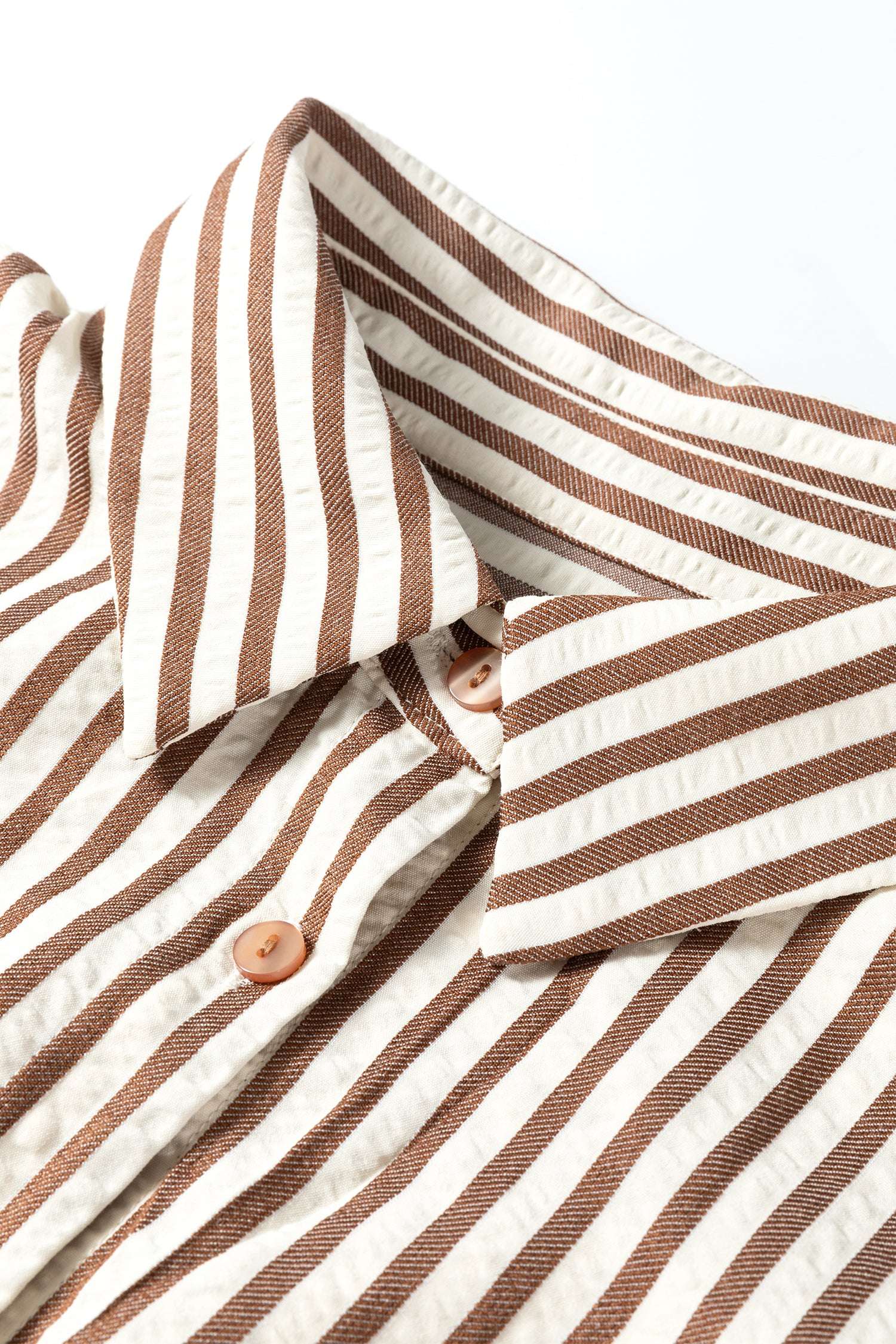 Collar and button detail of brown striped midi shirt dress, emphasizing the shirt dress style and spring-ready design.