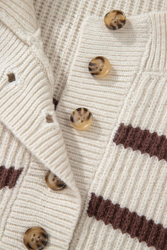 Detail of button placket and ribbed knit texture on striped Henley jumper. Brown buttons on soft beige knit for women’s casual tops.
