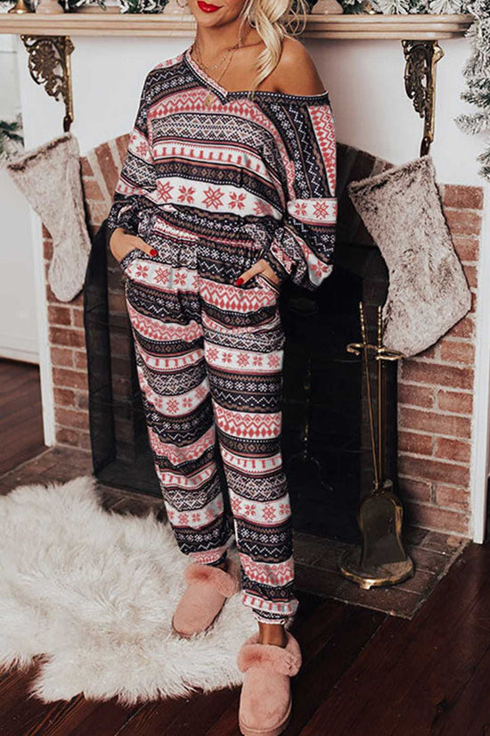 Women's Christmas Comfort Lounge Set in Black by FashionFitz featuring a festive retro pattern, worn in a cozy holiday living room setting.