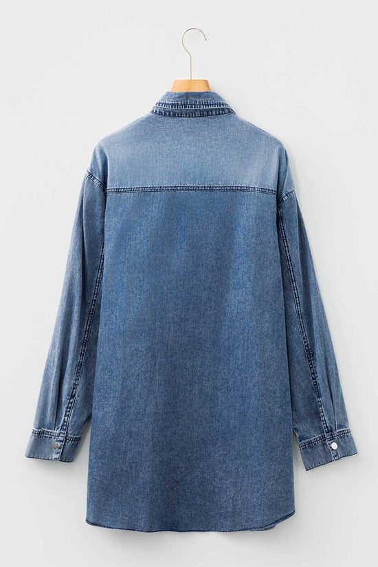 Back flat lay of oversized denim dress women in medium blue, showing long sleeves, yoke seam, and curved hem for casual autumn styling.