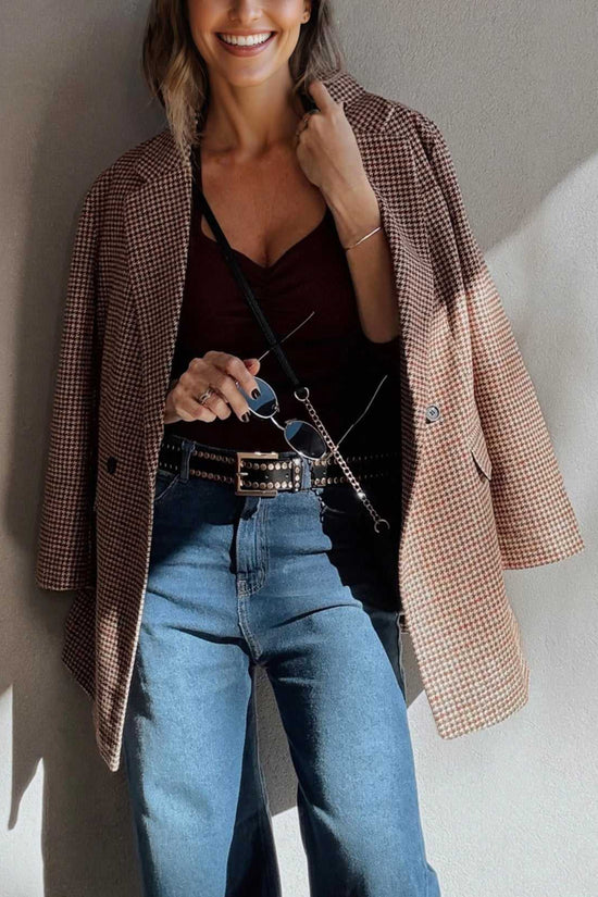 Ladies Brown Houndstooth Fitted Blazer draped over shoulders with a burgundy top and studded belt, styled for a chic fall ensemble.