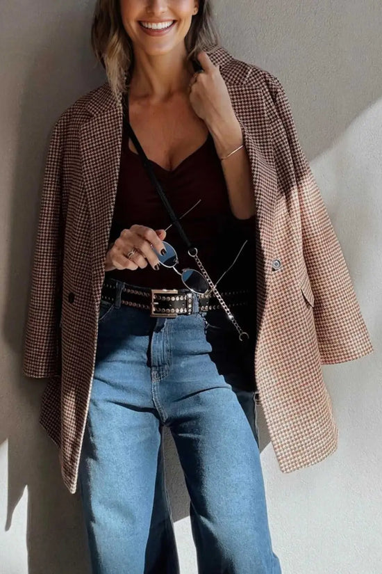 Ladies Brown Houndstooth Fitted Blazer draped over shoulders with a burgundy top and studded belt, styled for a chic fall ensemble.