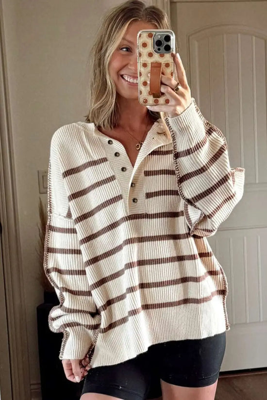 Casual slouchy striped Henley jumper styled with black biker shorts, featuring ribbed knit texture and brown stripes.