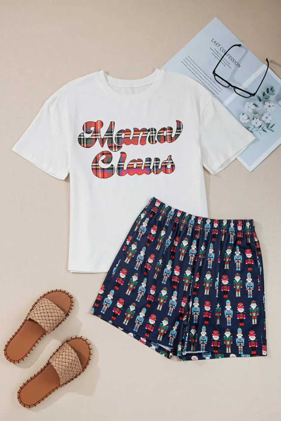 Flat lay of FashionFitz UK Ladies Nutcracker Christmas Lounge Set including white 'Mama Claus' tee and navy nutcracker shorts, ideal for holiday loungewear.