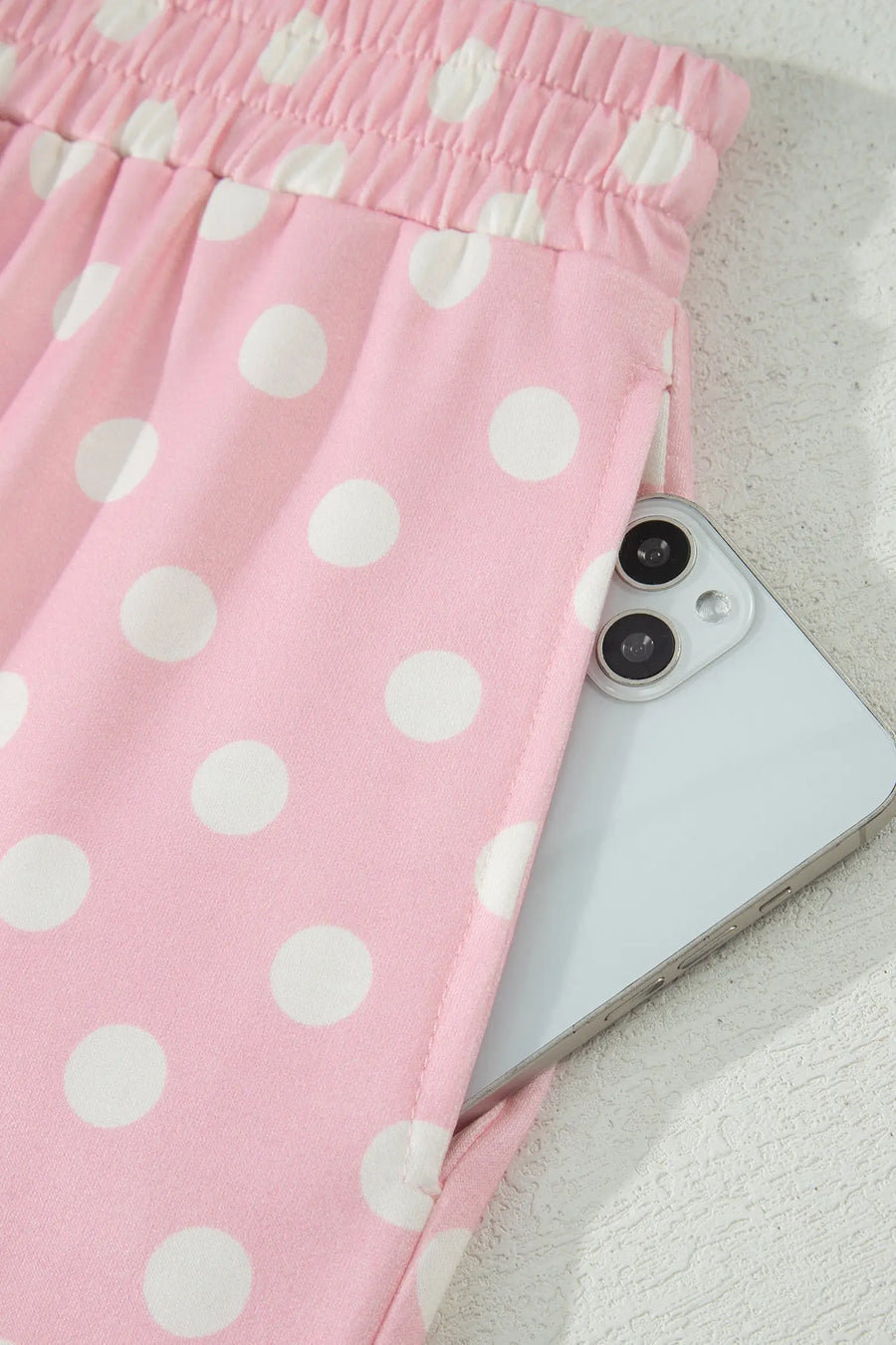 Women's polka dot mock neck top shift pants close-up detail