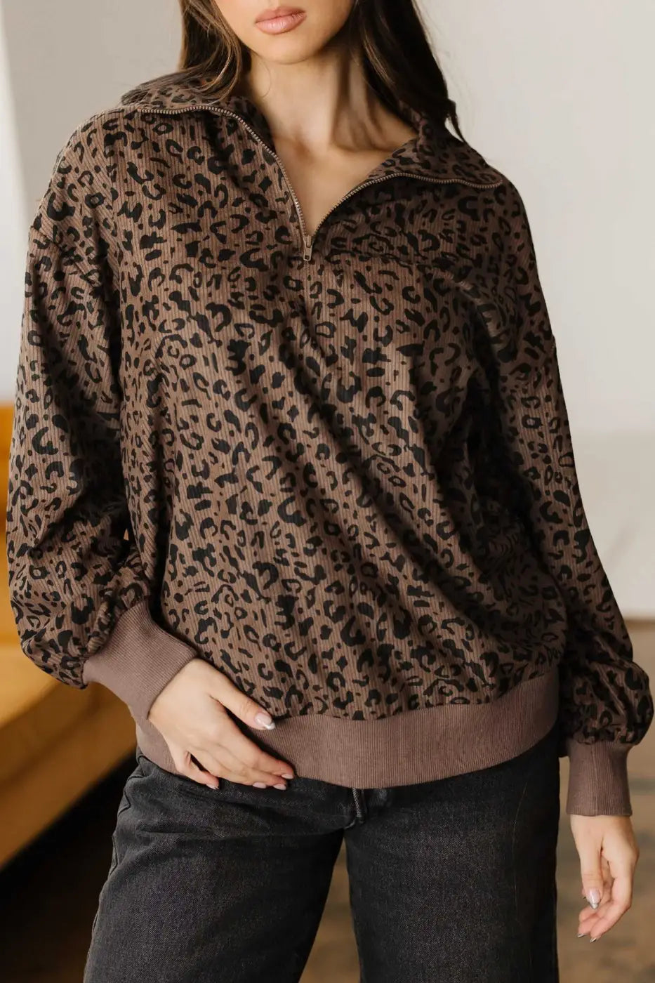 Model wearing Women's Brown Leopard Print Corduroy Half-Zip Jumper, highlighting the half-zip neckline and relaxed silhouette.