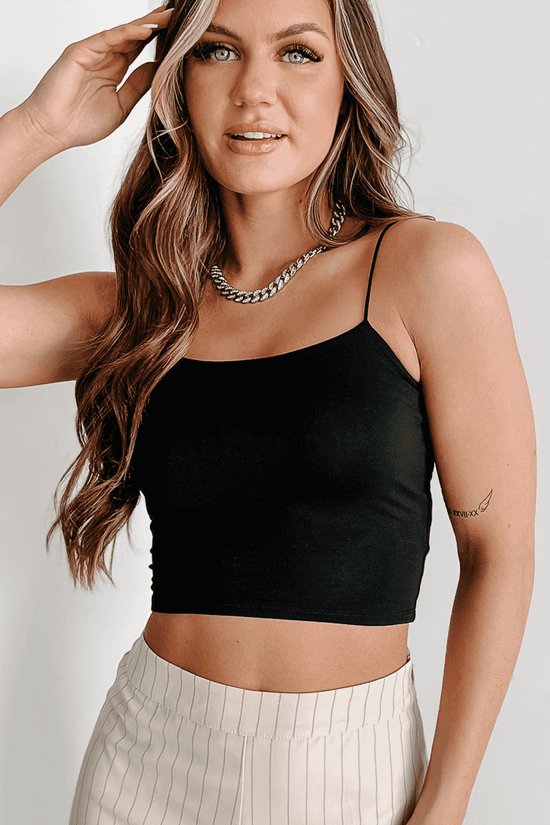 Close-up of black skinny fit crop top with spaghetti straps, highlighting its sleek and flattering silhouette.
