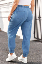 Back view of Plus Size Blue Denim Joggers with elastic waistband and rear patch pockets, ideal for daily comfort and fall fashion.