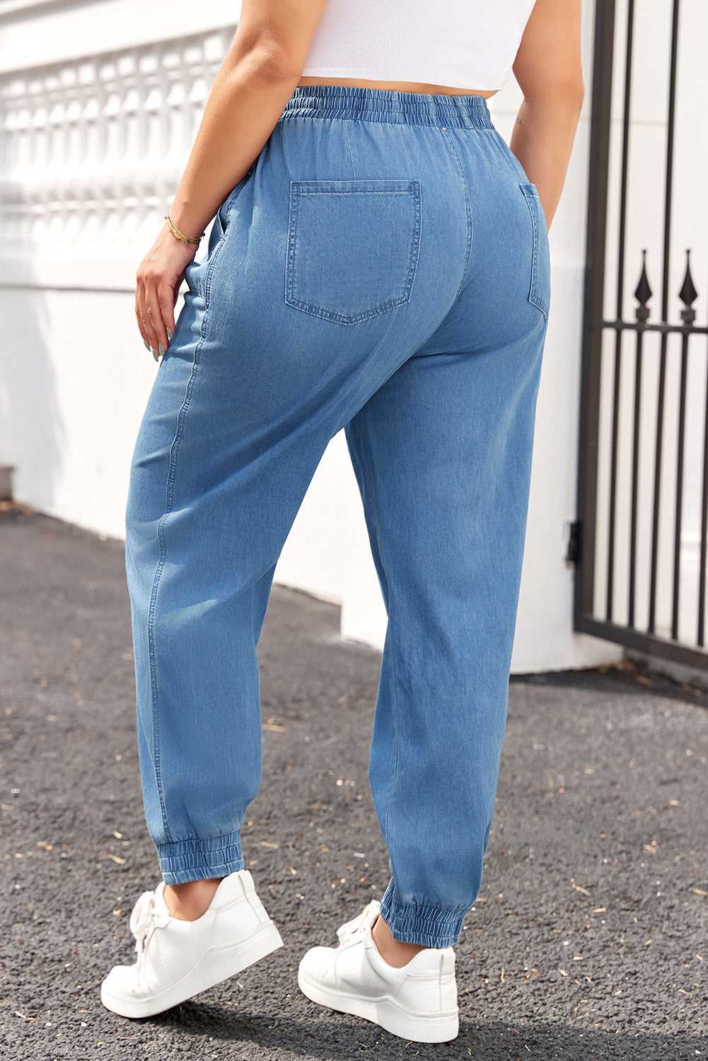 Back view of Plus Size Blue Denim Joggers with elastic waistband and rear patch pockets, ideal for daily comfort and fall fashion.