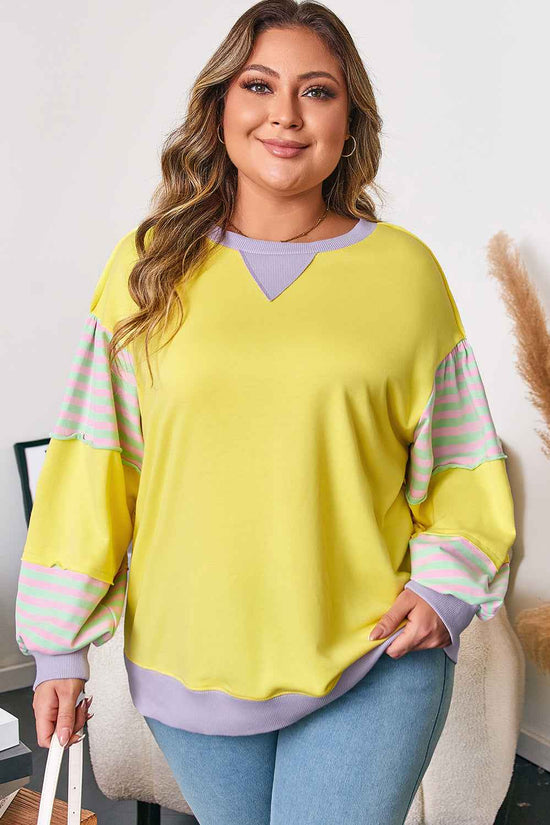 Front view of plus size yellow sweatshirt with pastel striped sleeves, ideal for casual daily wear in fall.