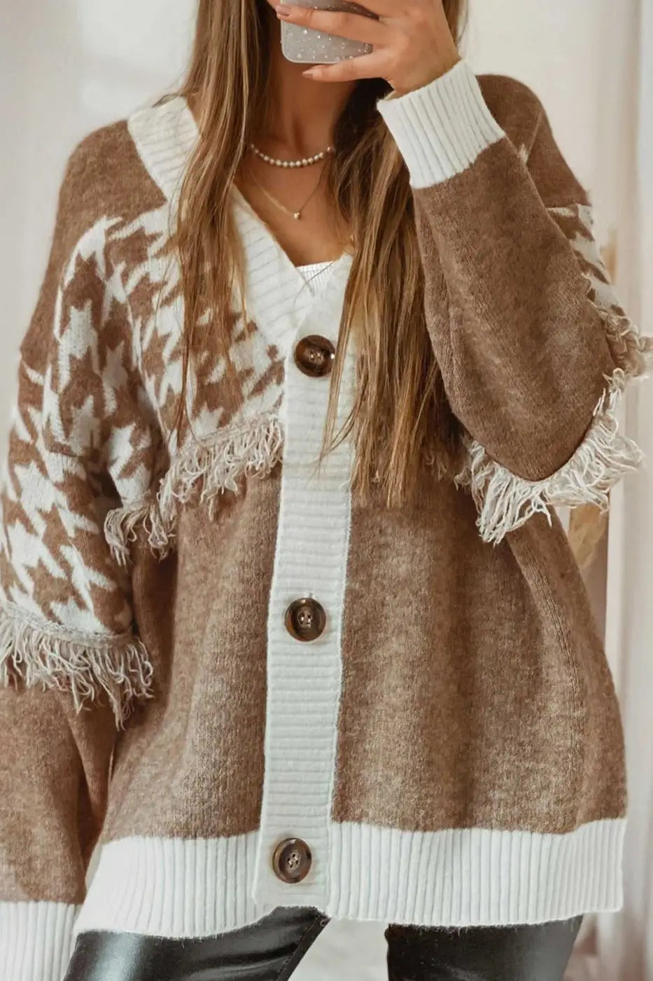 Khaki houndstooth knit cardigan with oversized fit, white ribbed trim, and fringe detail. Ideal for women’s smart-casual fall layering.