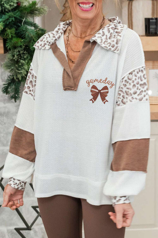 Embroidered Leopard Polo – Chic White Long Sleeve Top with leopard print collar and sleeves, 'gameday' text and football bow graphic detail.