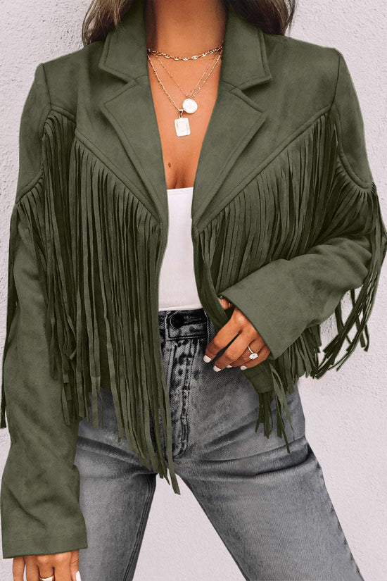 Ladies green cropped fringe faux suede jacket with long tassels, styled with a white top and high-waisted gray jeans for a chic western look.