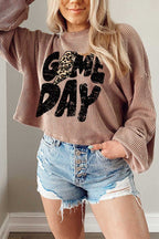 Person wearing a Game Day Graphic Crop Top, paired with denim shorts.