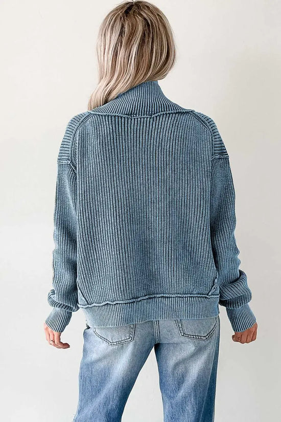 Back view of blue stonewash patchwork knit open cardigan, highlighting ribbed knit texture and relaxed silhouette.
