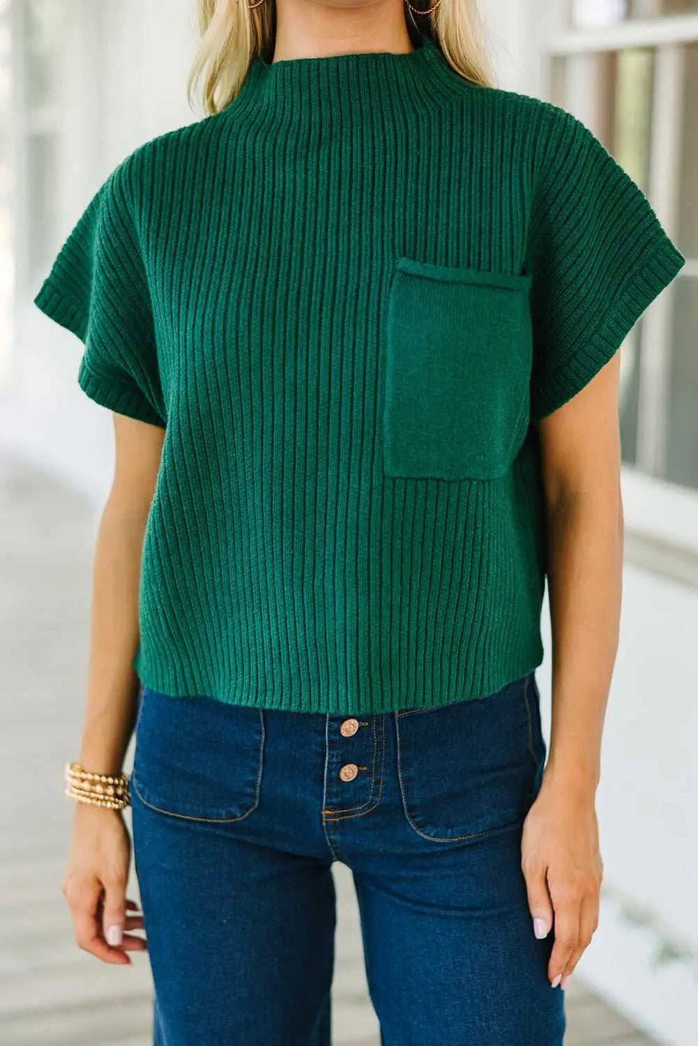 Green Ribbed Knit Short Sleeve Sweater paired with wide-leg jeans and white boots, ideal for casual fall fashion.