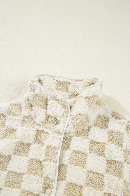 Close-up of a checkered Sherpa Fleece Vest with a neutral color scheme on a beige background