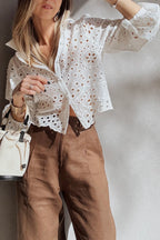 Woman wearing a White Cutwork Embroidered Crop Top and brown pants, holding a white handbag.