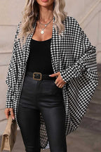 Person wearing a Black Houndstooth Dolman Kimono Wrap with a blurred background
