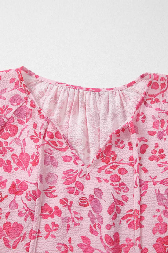 Back view of Pink Floral Lightweight Blouse on hanger, showing full floral pattern and relaxed fit.