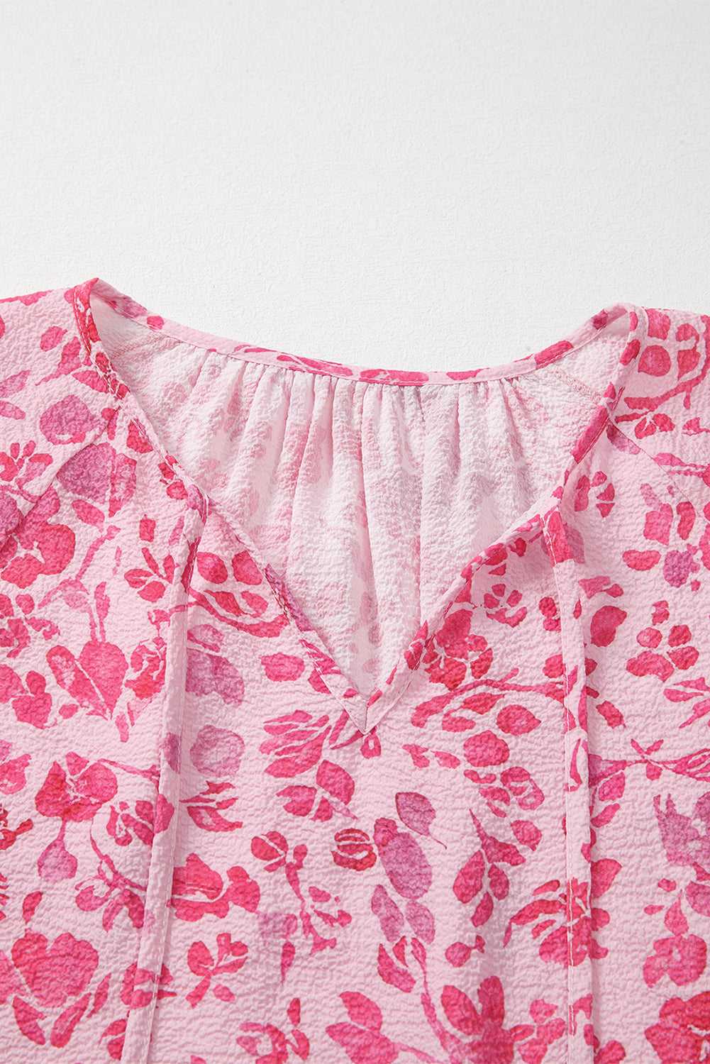 Back view of Pink Floral Lightweight Blouse on hanger, showing full floral pattern and relaxed fit.