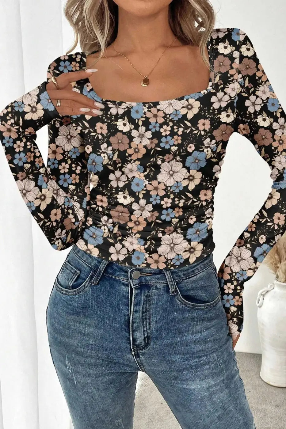 Front view of black floral slim long sleeve top featuring soft pastel floral print and fitted silhouette for everyday wear.