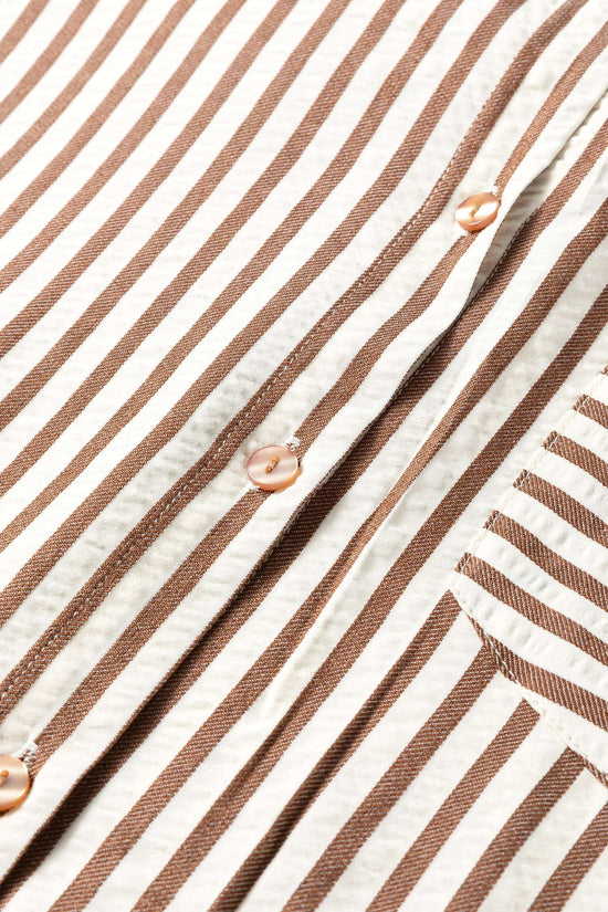 Close-up of brown striped midi shirt dress button placket, highlighting the vertical stripe pattern and stitching detail.