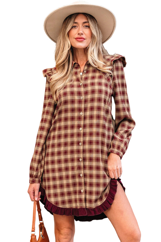 Woman wearing a plaid dress with a hat in an outdoor setting