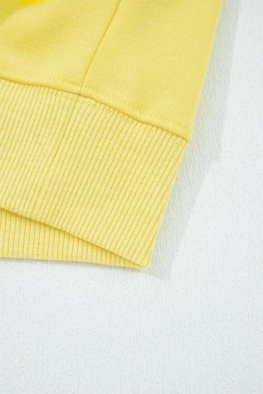 Hem detail of yellow Drop Crop Wide-Leg Pants Set top, showing ribbed edge for a polished loungewear look.