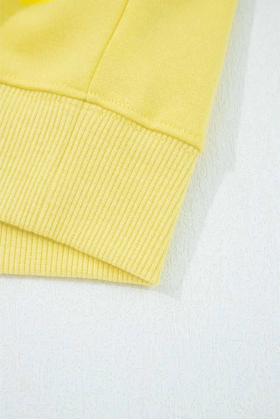 Hem detail of yellow Drop Crop Wide-Leg Pants Set top, showing ribbed edge for a polished loungewear look.