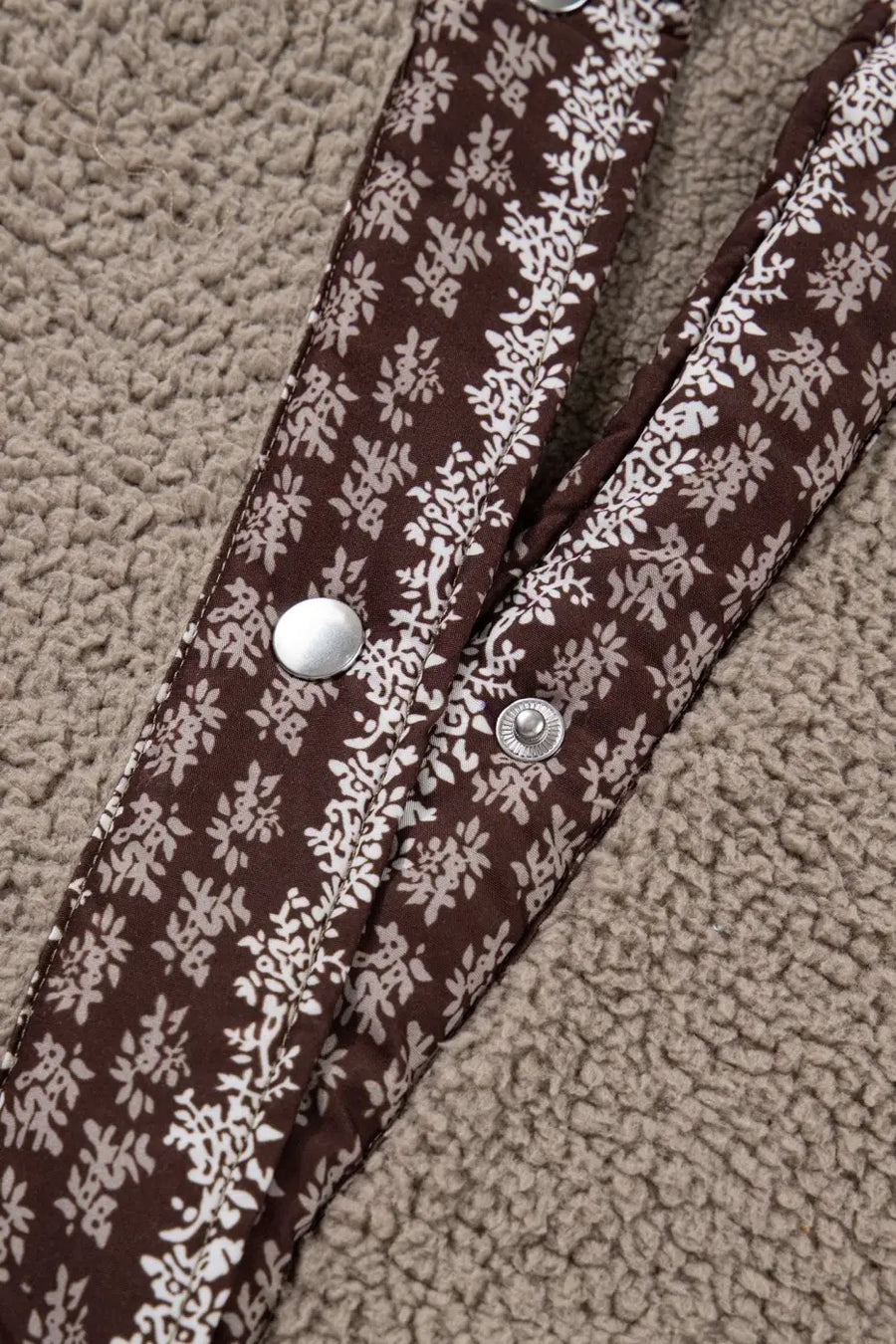 Detailed view of snap button closure and floral trim on Women's Country Borg Fleece Gilet Winter Vest FashionFitz in khaki fleece.