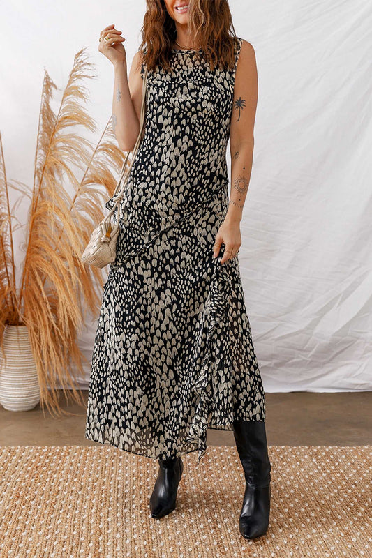 Black Floral Sleeveless Maxi Dress styled with boots and a shoulder bag, perfect for summer garden parties or casual outings.