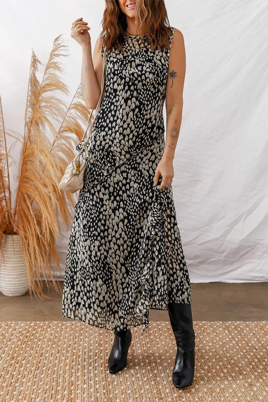 Black Floral Sleeveless Maxi Dress styled with boots and a shoulder bag, perfect for summer garden parties or casual outings.