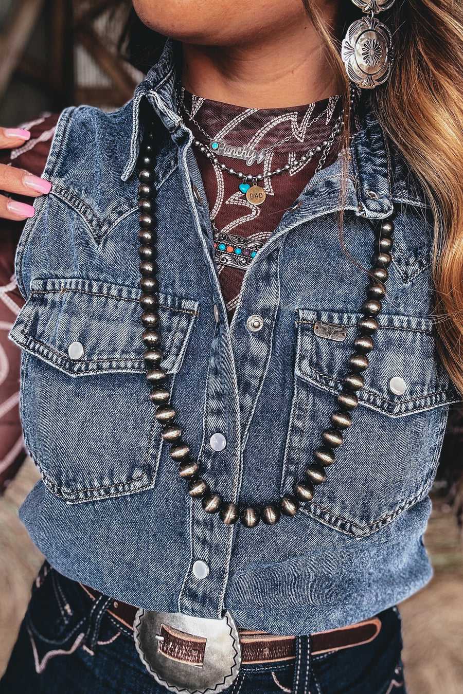 Blue denim cowboy vest styled over white tee and straight jeans — Fashionfitz UK