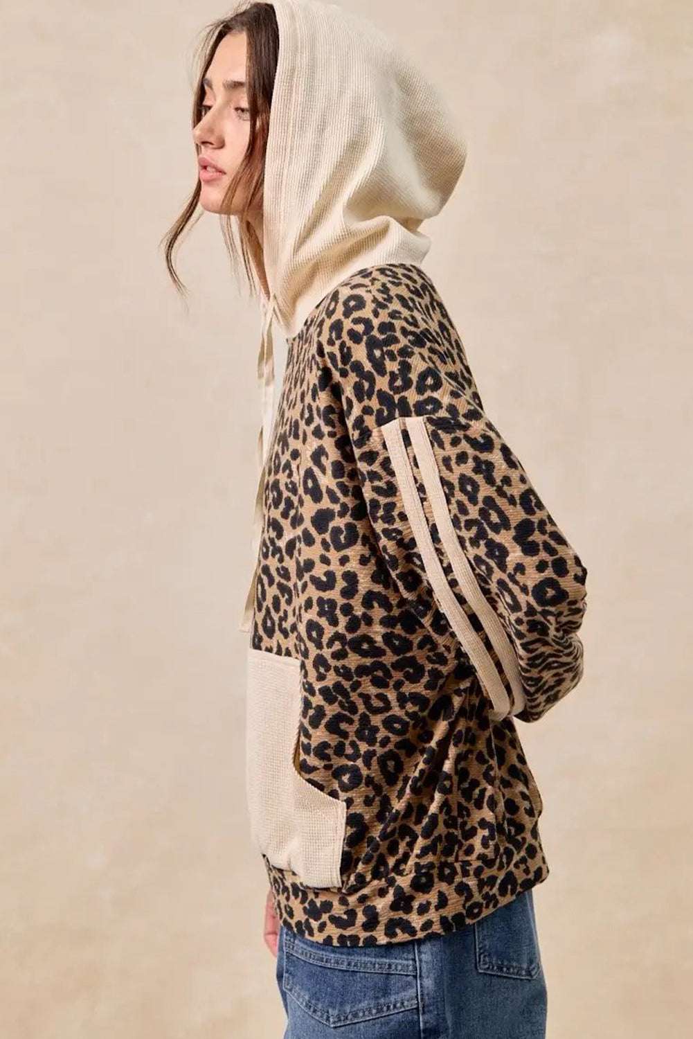 Side profile of Leopard Print Waffle Knit Kangaroo Hoodie featuring beige hood and striped sleeves, perfect for autumn layering.